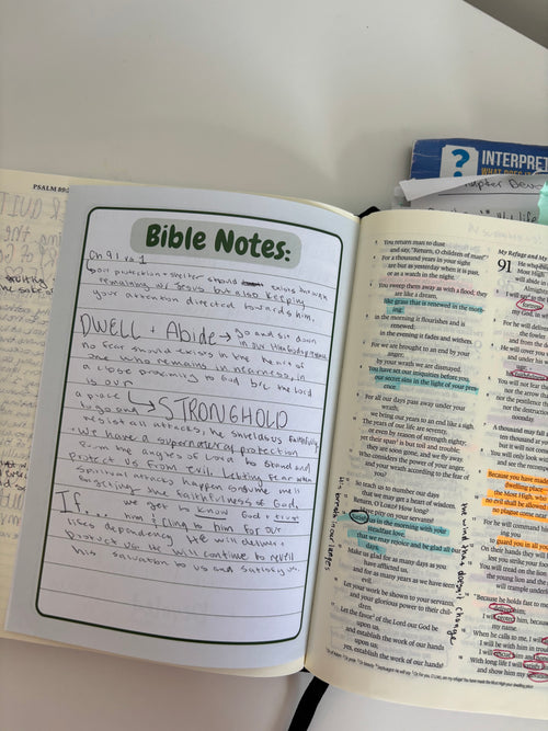 Open Bible with 'Bible Notes' section on a white surface