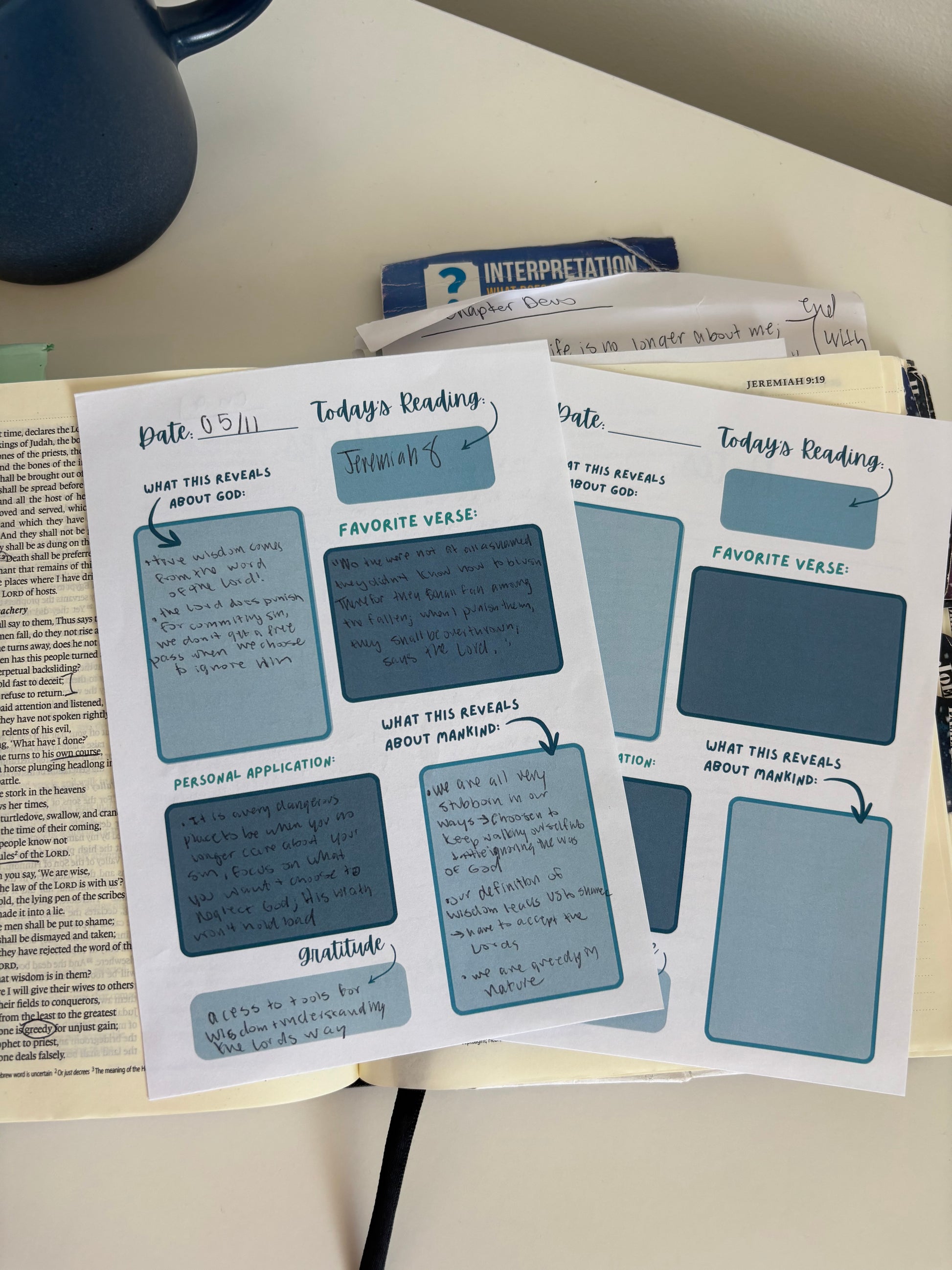 Sheet of printed forms with blue text boxes on a desk