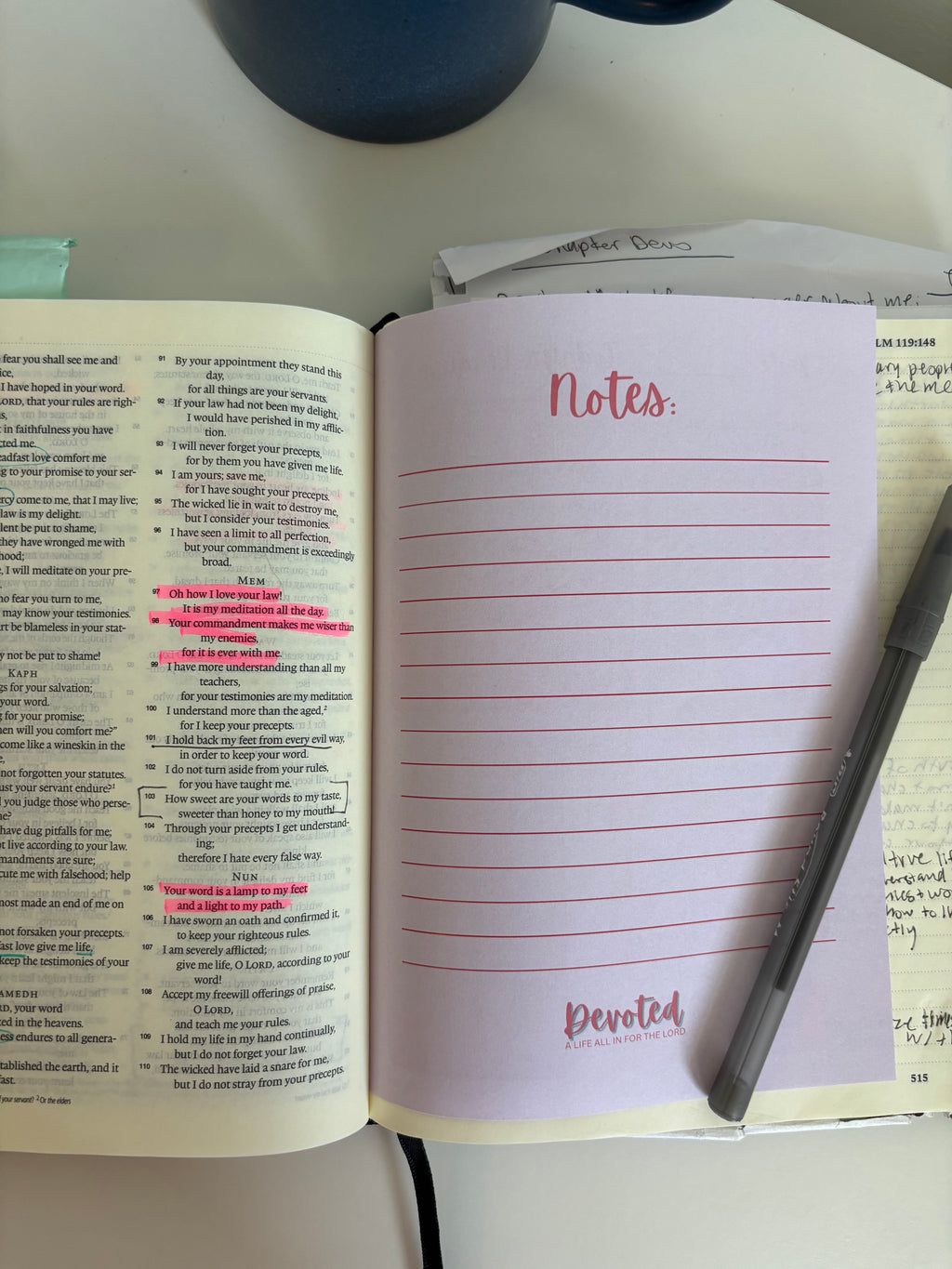 Open book with handwritten notes on a desk