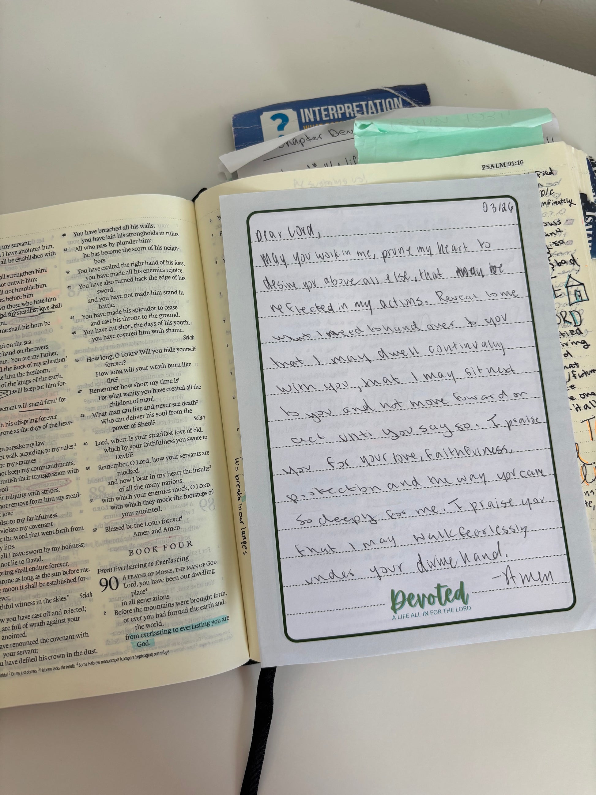 Open book with handwritten notes on a white surface