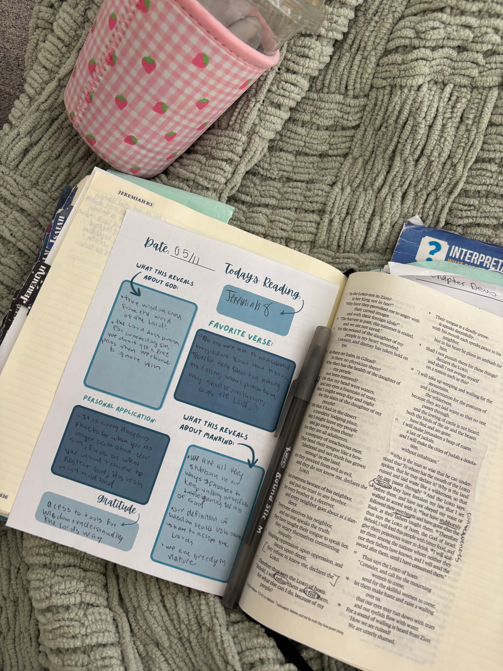 Open book with a guided bible note sheets on a Bible 
