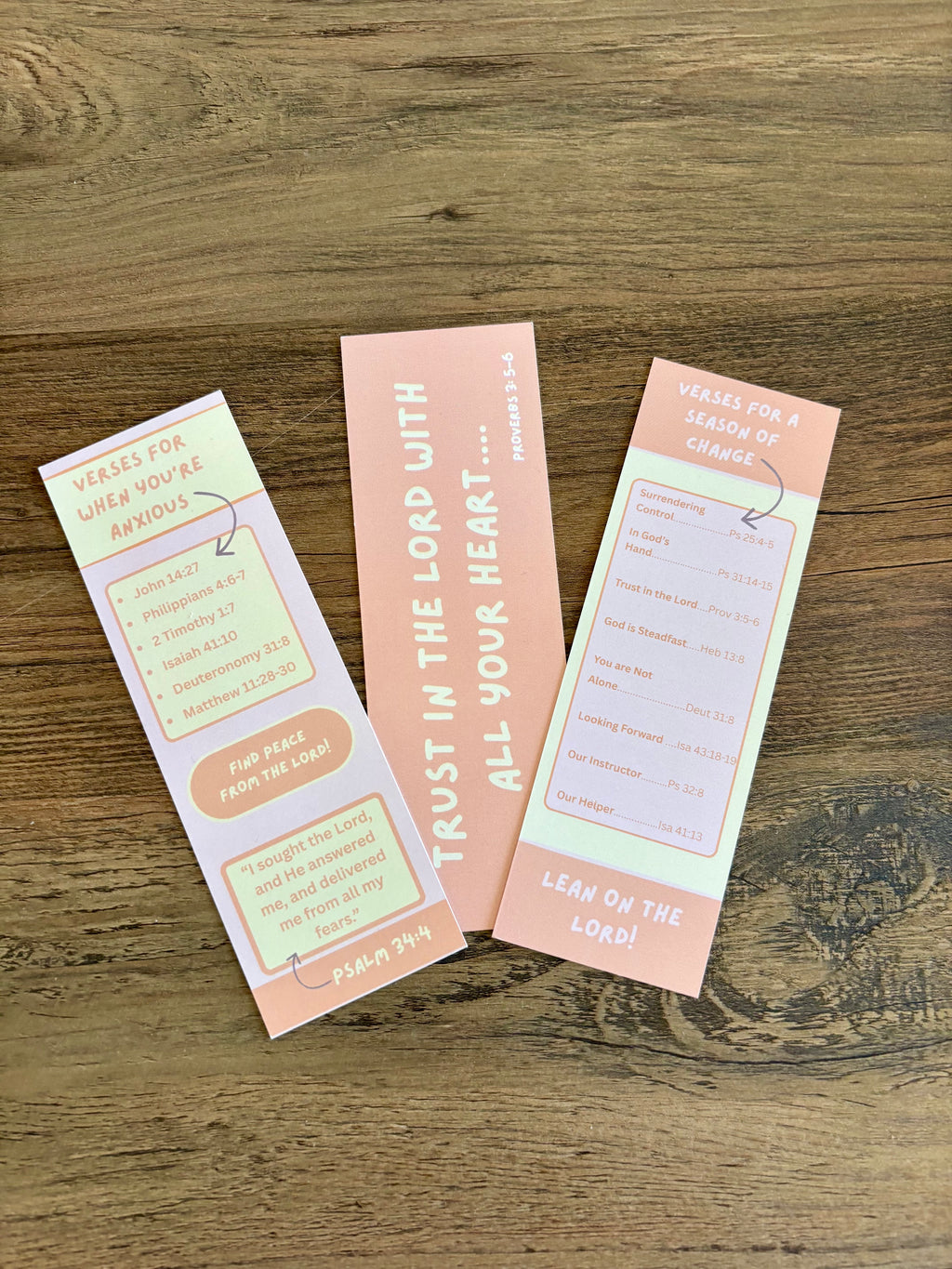 Three motivational bookmarks on a wooden surface