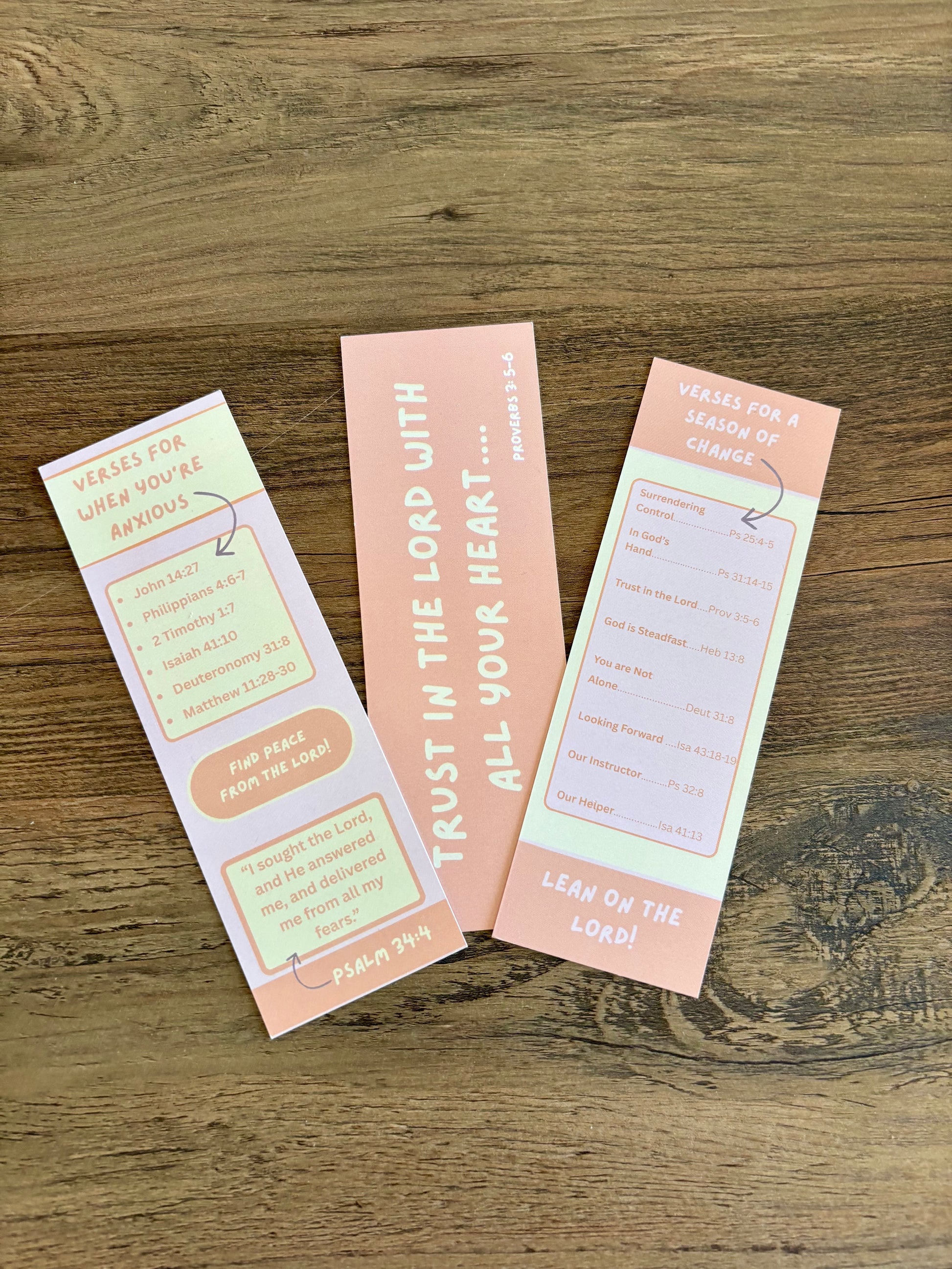 Three motivational bookmarks on a wooden surface
