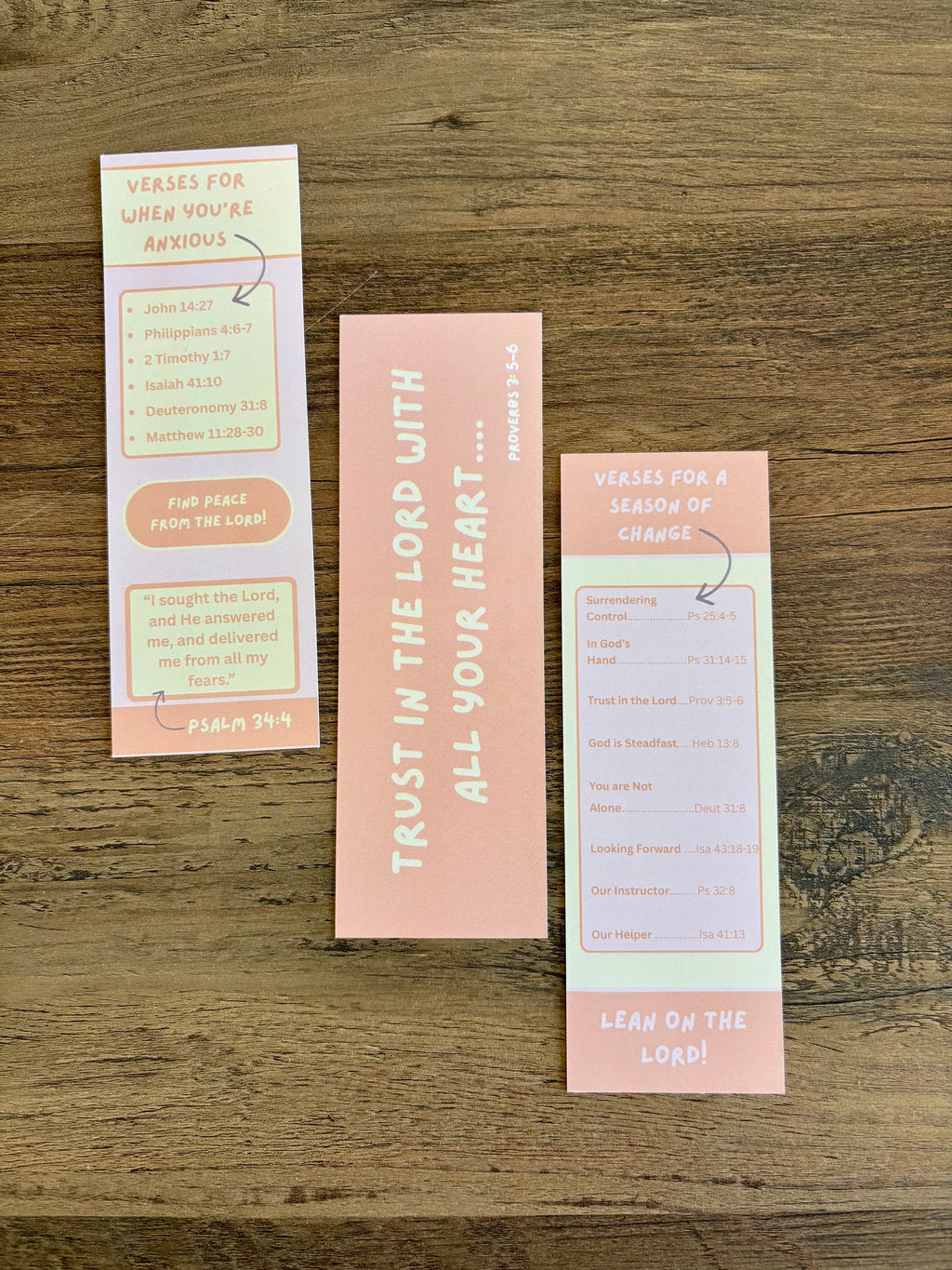 Three motivational bookmarks on a wooden surface