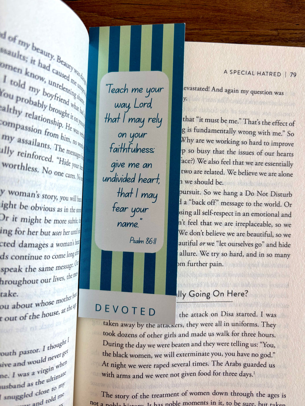 Book with a bookmark featuring a prayer and decorative stripes on an open book.