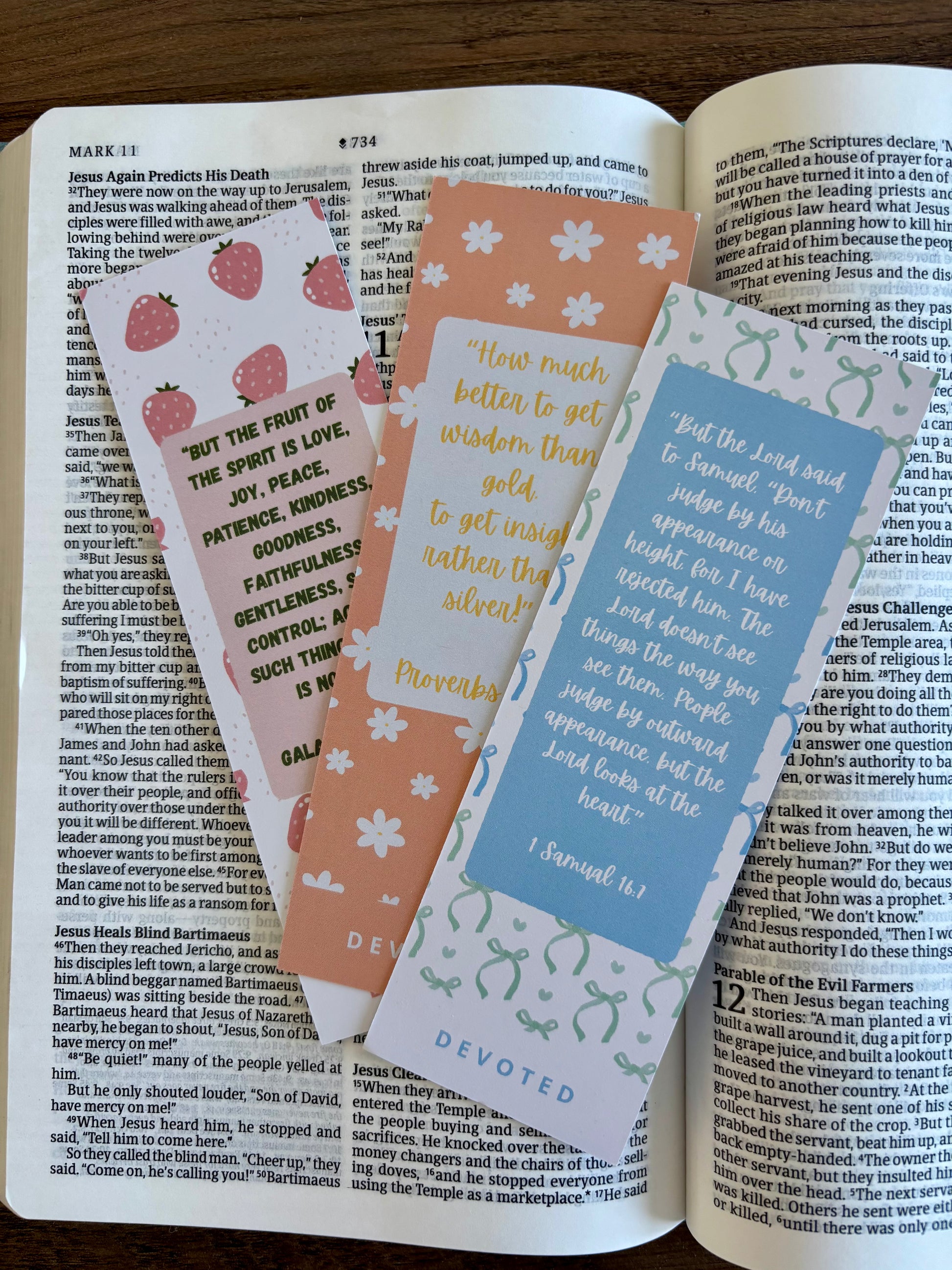 three colorful bookmarks with text and designs on an open book
