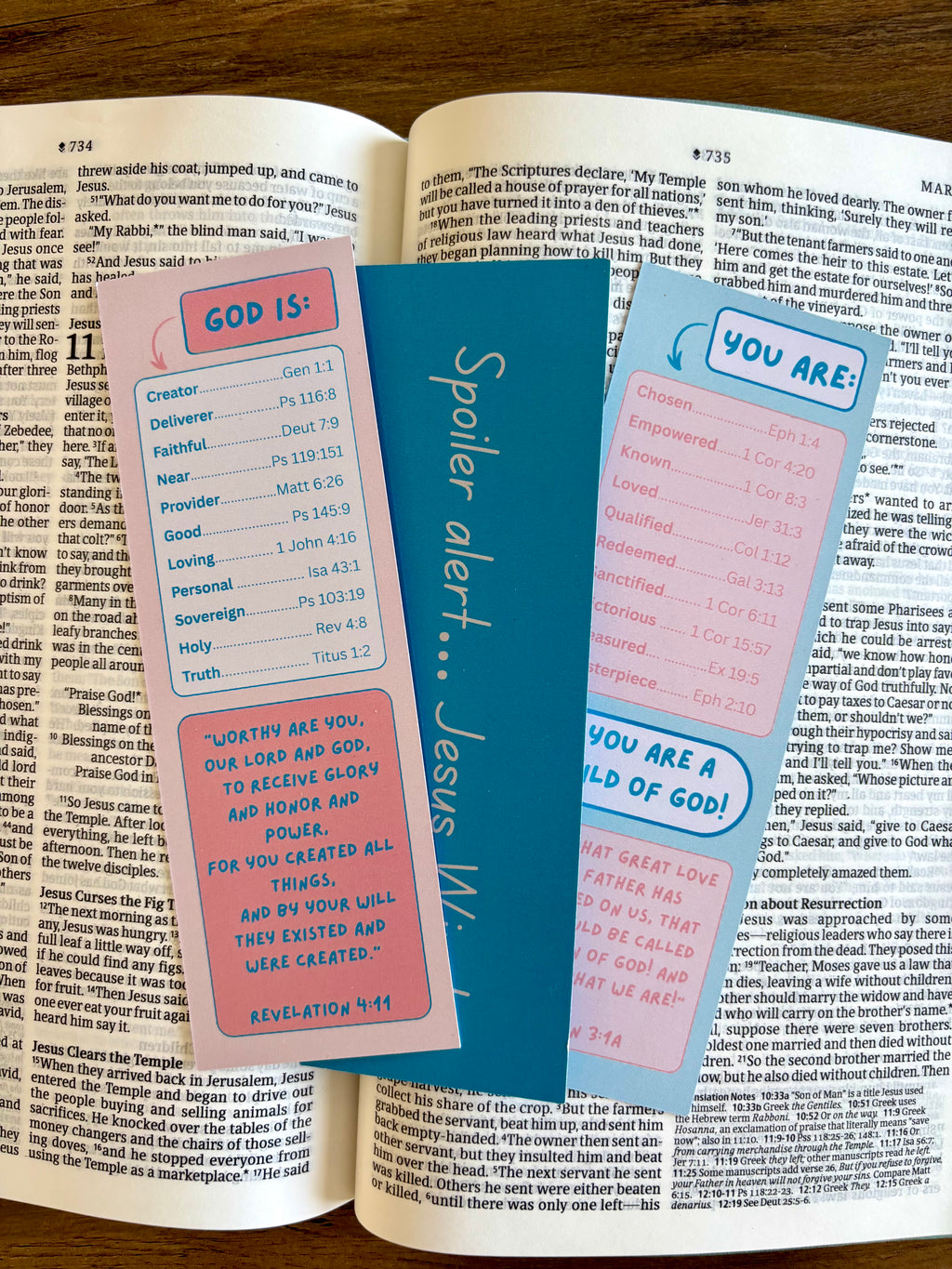 Three colorful bookmarks with text on an open book