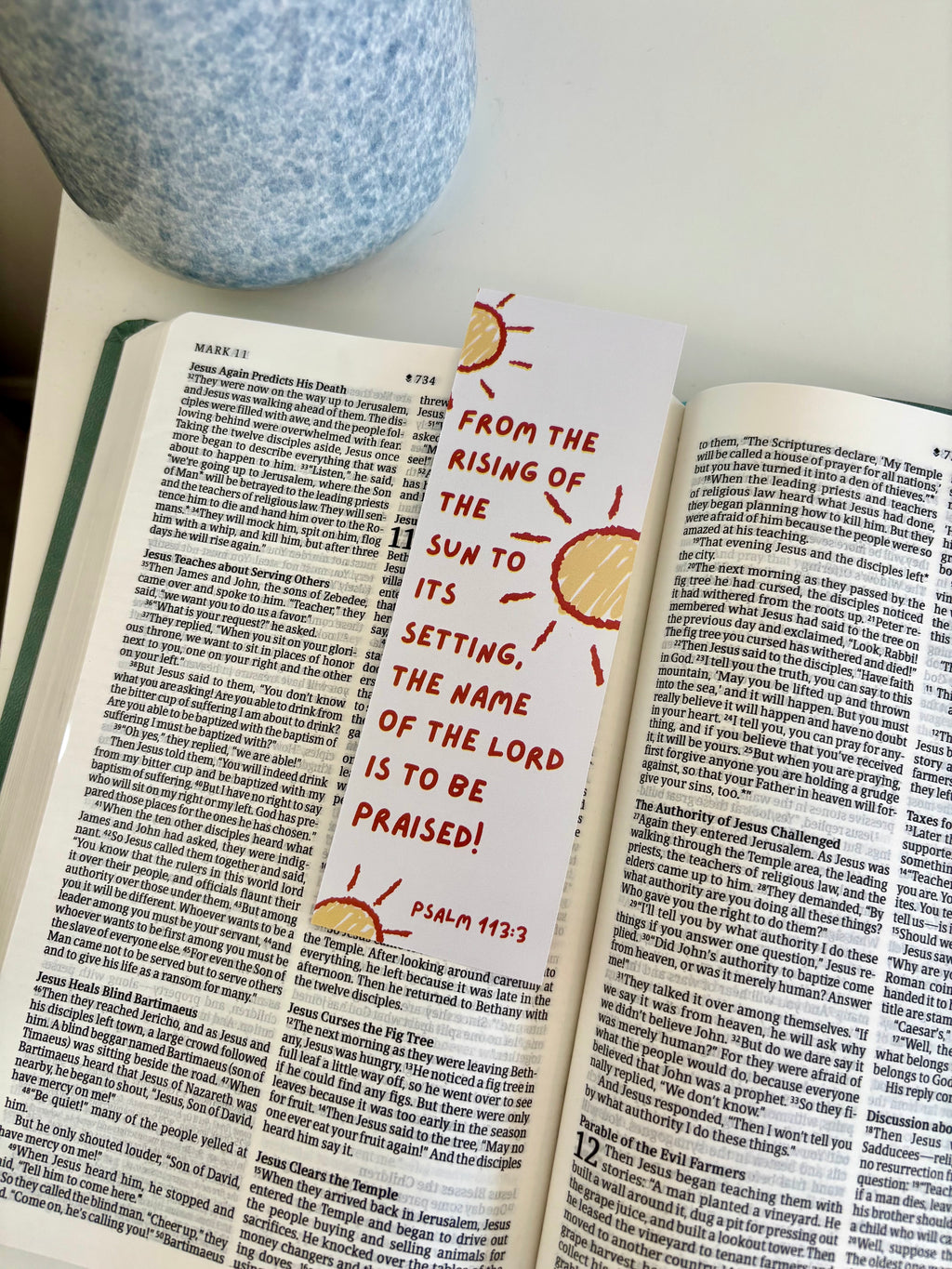 Open book with a decorative bookmark featuring Psalm 113:3 text.