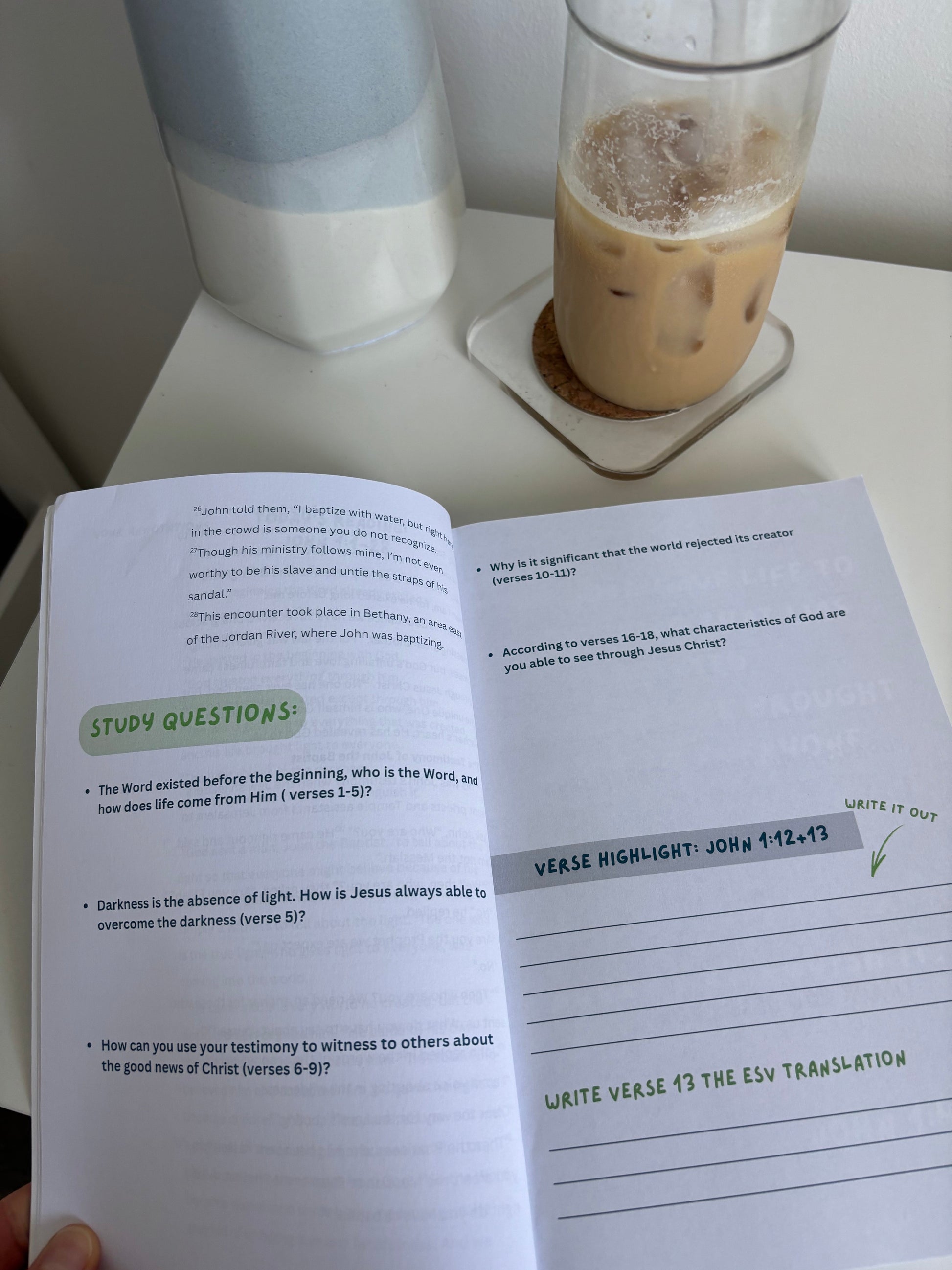 an open journal on a desk with a cofee