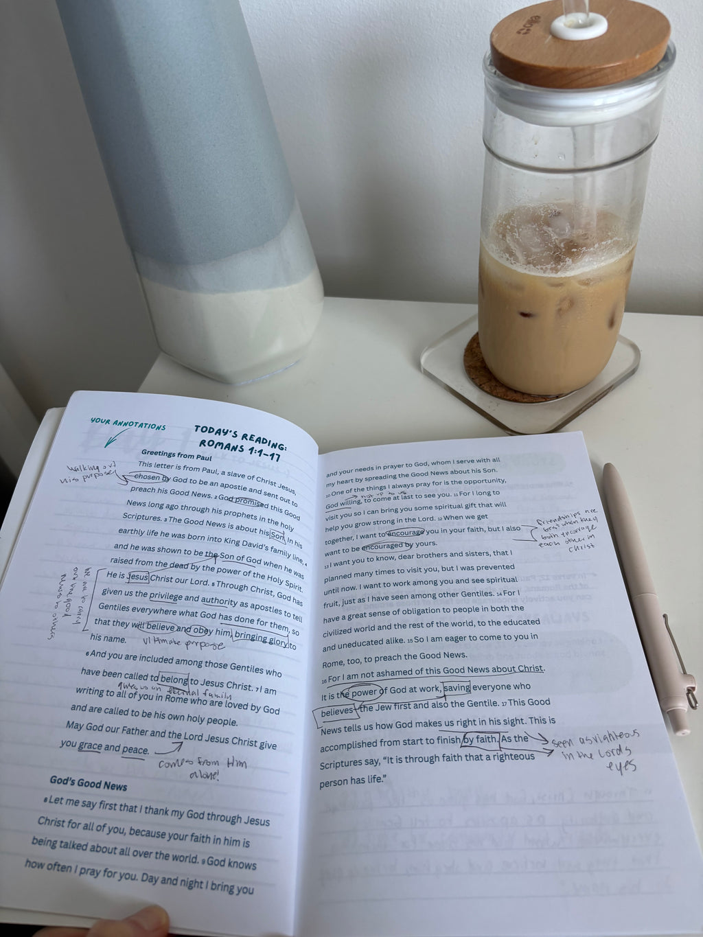 open bible study book on a table with scripture and notes written on the page