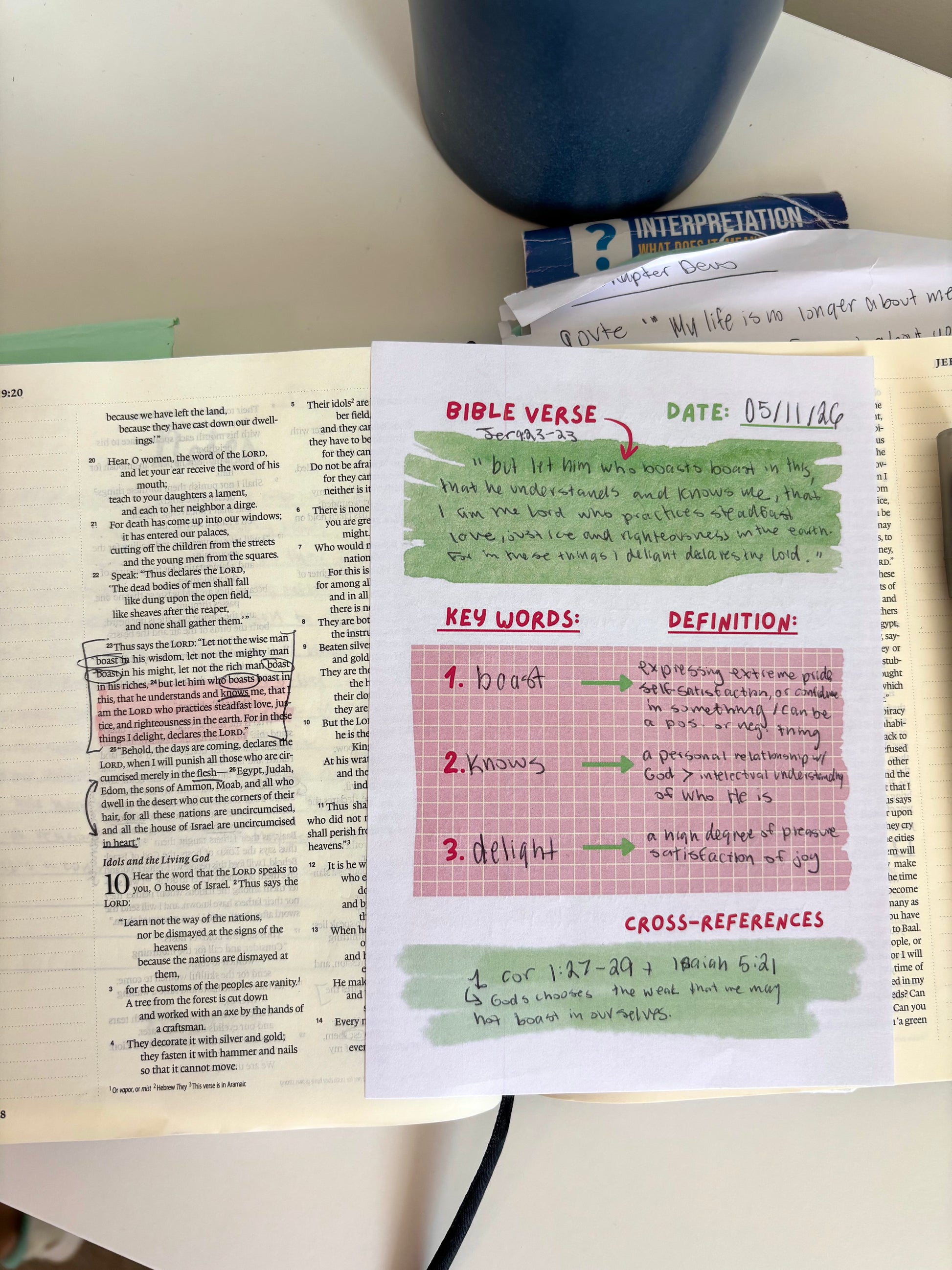 Notebook page with Bible verse, key words, and definitions on a desk.
