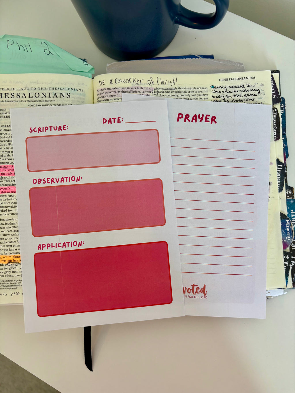 Notebook with prayer journal pages on a table