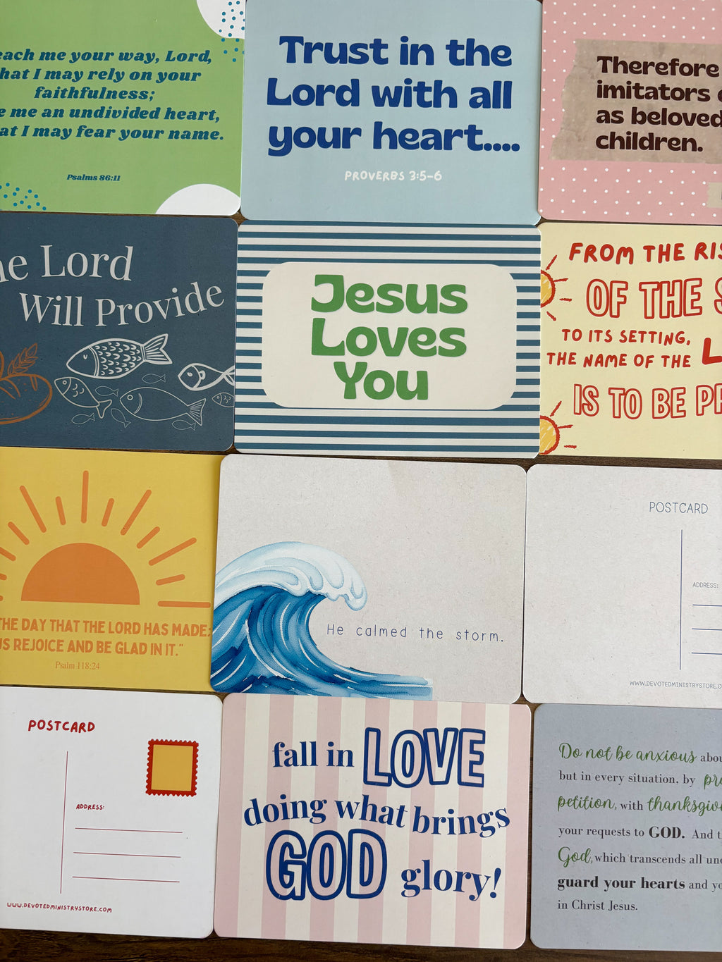A grid of colorful Bible postcards featuring various verses, illustrations, and inspirational designs.