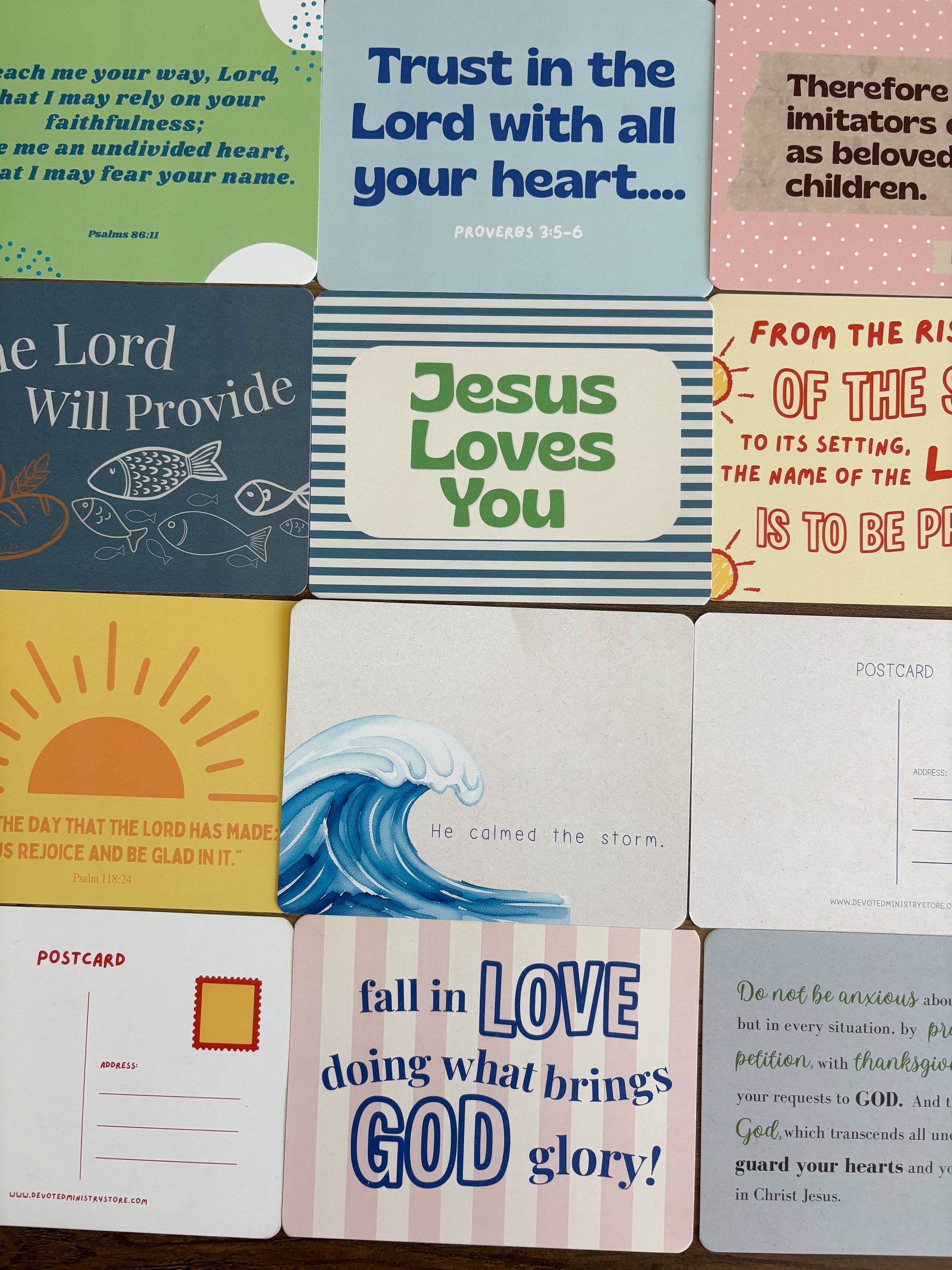 A grid of colorful Bible postcards featuring various verses, illustrations, and inspirational designs.