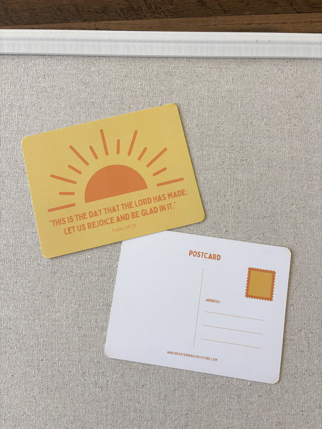 A postcard set featuring a yellow front with an orange rising sun and the quote 'THIS IS THE DAY THAT THE LORD HAS MADE. LET US REJOICE AND BE GLAD IN IT.