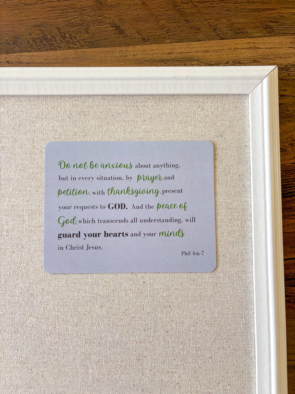 Christian postcard, light purple, displayed in a cork board