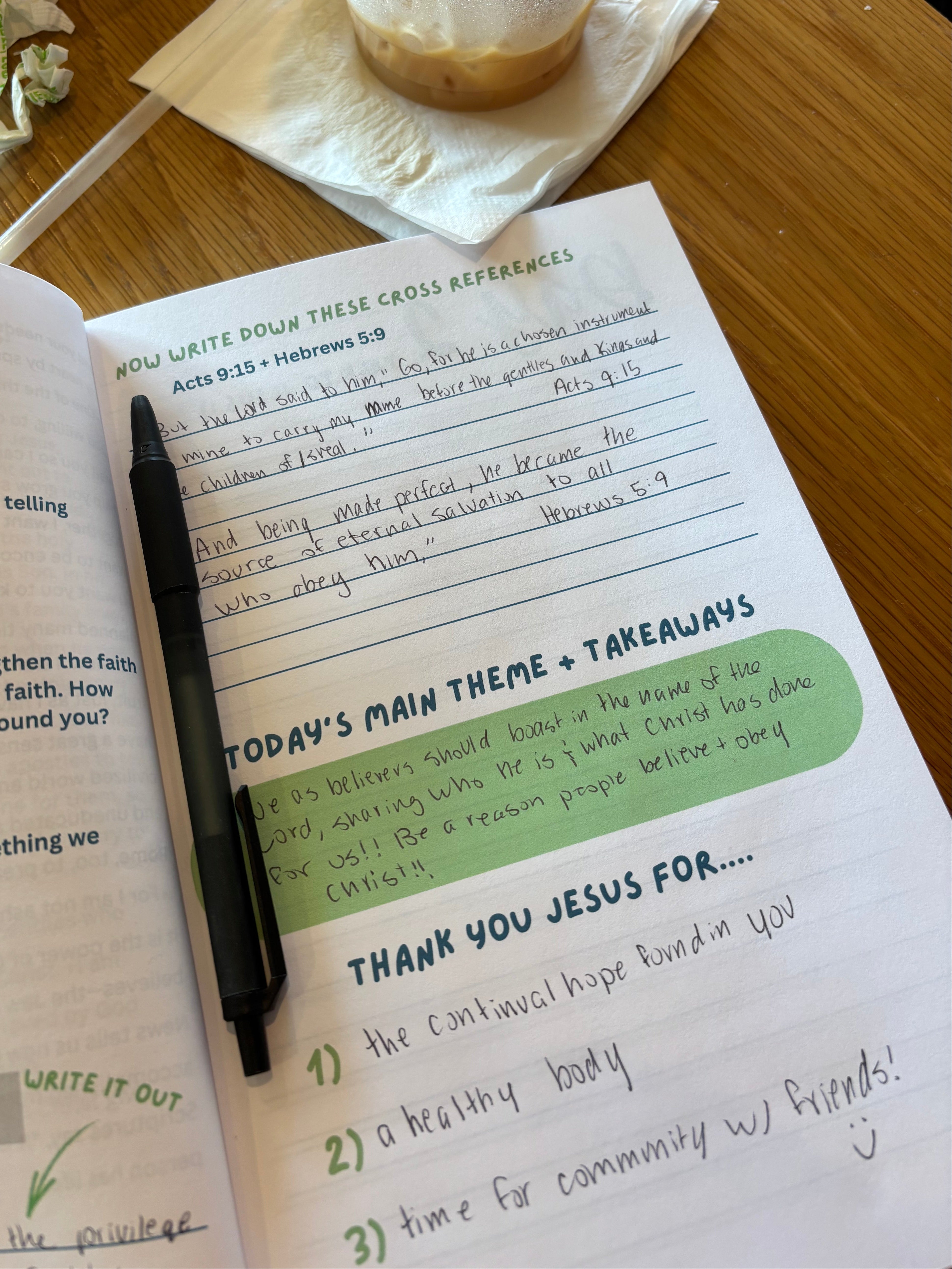 Romans All-In-One Bible Study Devotional, opened up and filled out at a coffee shop. 