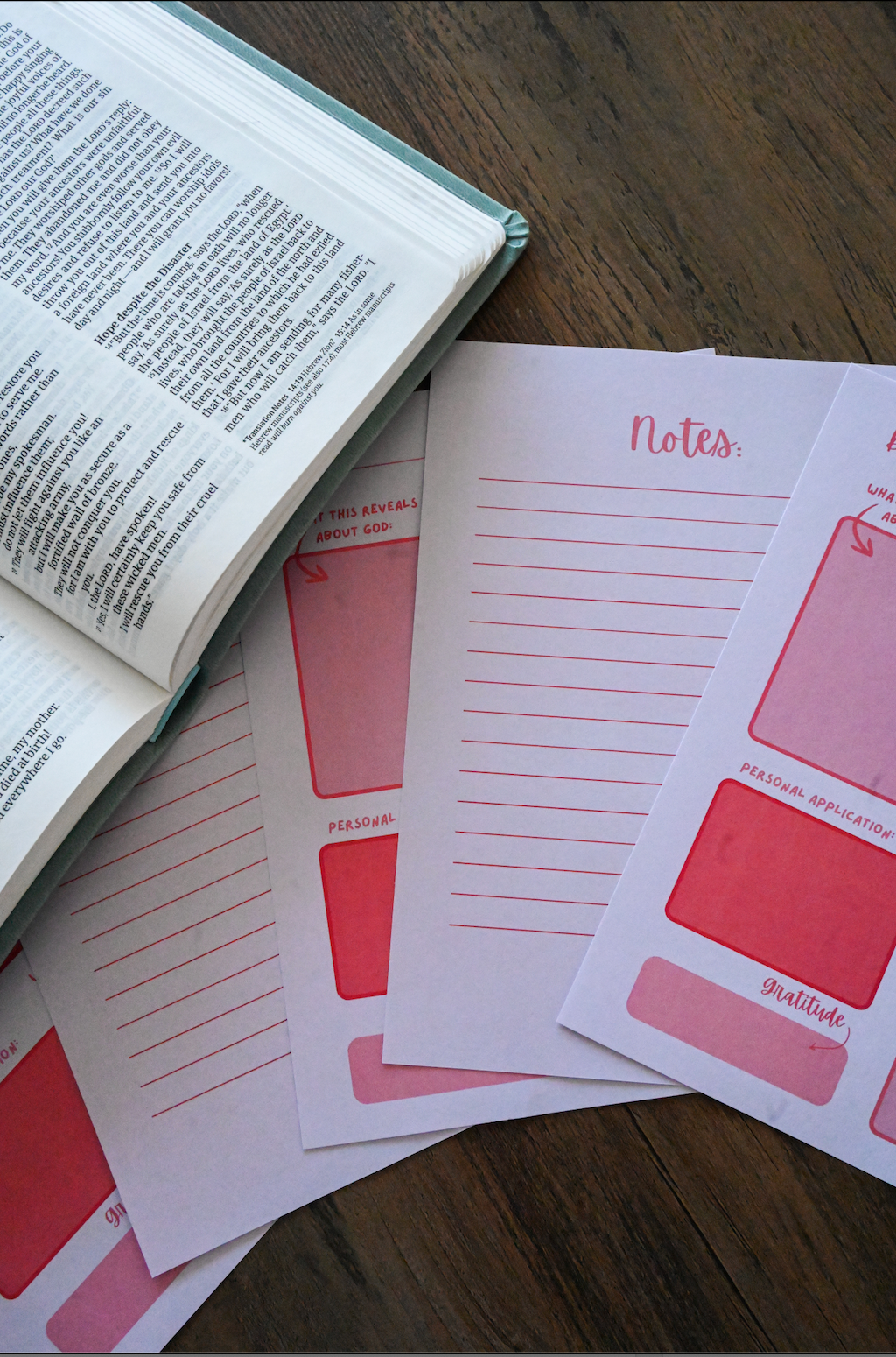 Notebook pages with pink design and 'Notes' text on a wooden surface